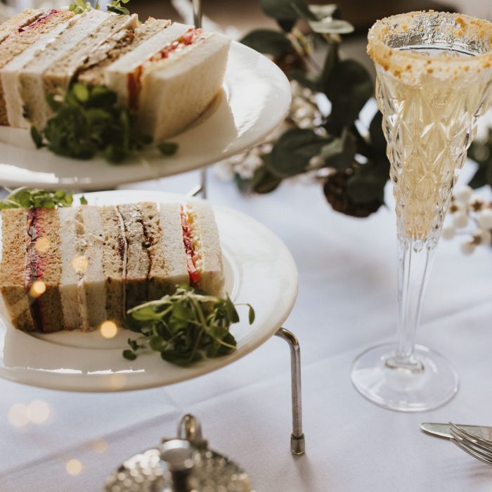 Sandwiches on a plate with a cocktail next to them